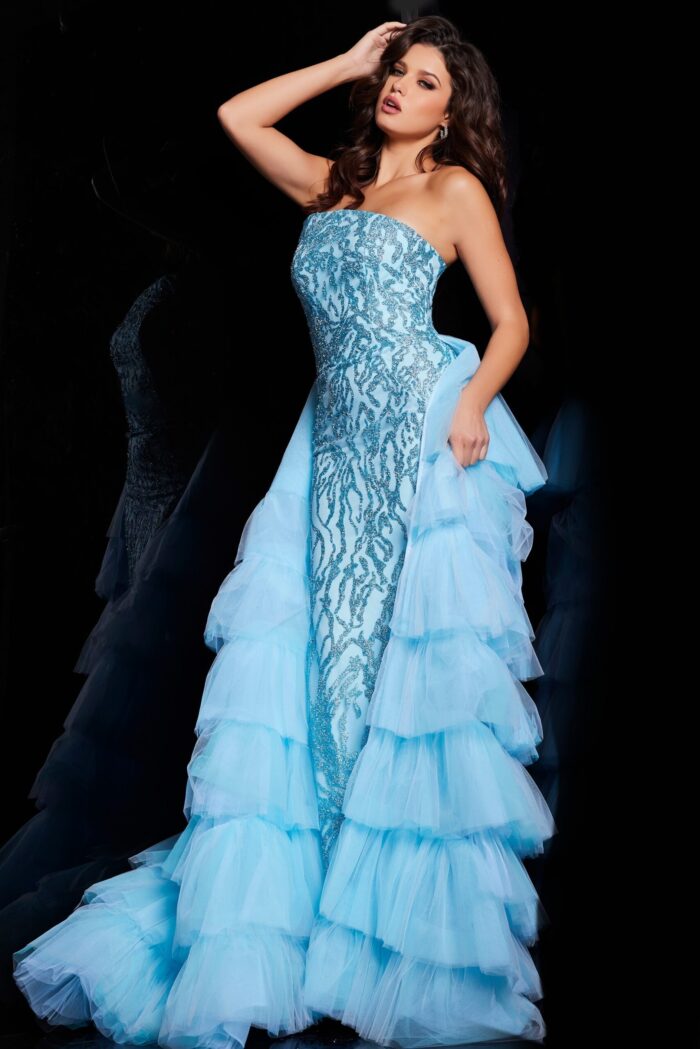 Model in Jovani 26119 blue dress, featuring a strapless neckline and layered tulle train.