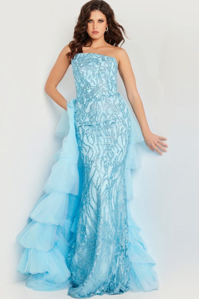 Model wearing Jovani 26119 blue dress with strapless neckline and layered tulle train, front view.