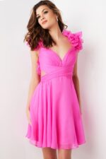 Model posing in Jovani 26139 pink dress showcasing ruffled shoulder design, front view.
