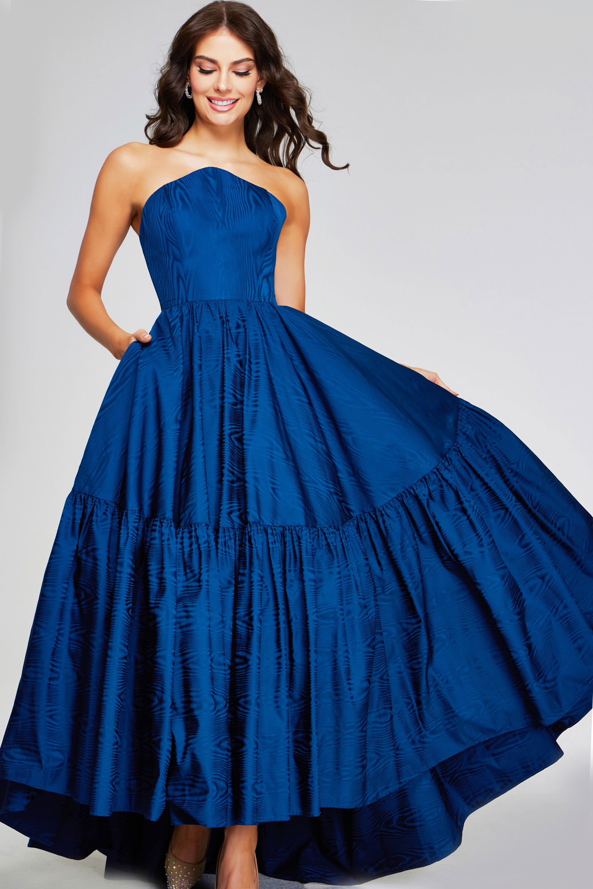 26152-208-3.jpg Model wearing Jovani 26152 with a navy A-line strapless gown, front view, full-length.