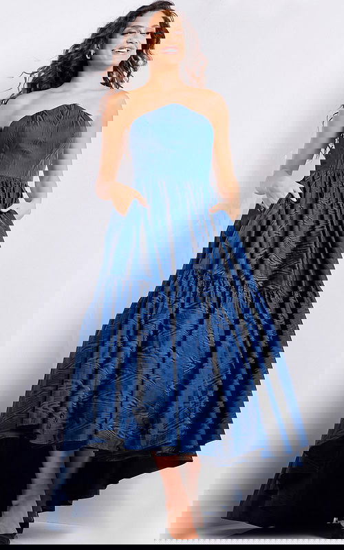 Model wearing Jovani 26152 navy dress featuring a high-low hemline.