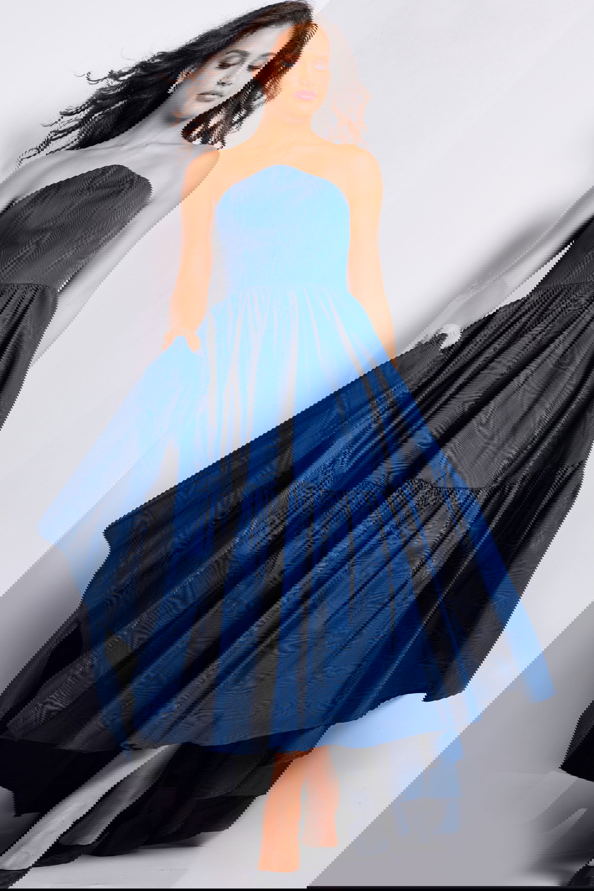 26152_NAVY_27.jpg Model wearing Jovani 26152 navy strapless dress with full skirt.