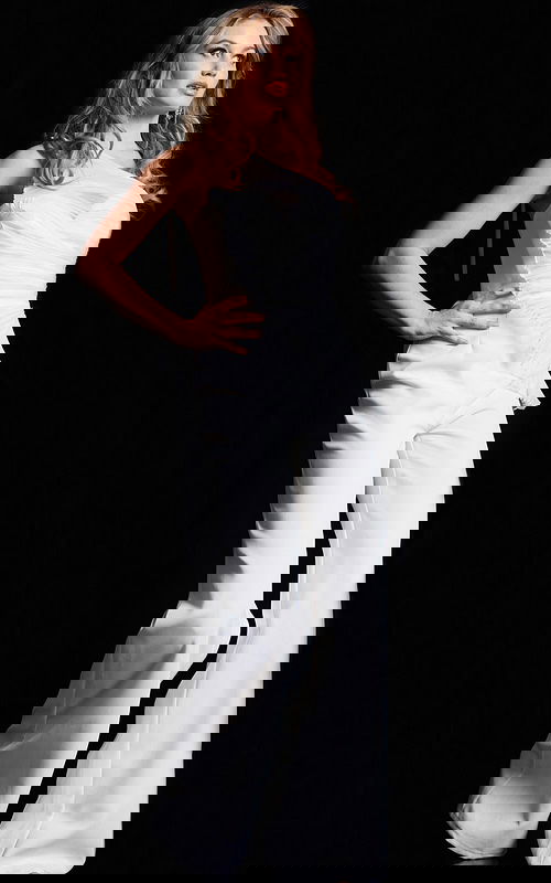 model wearing 26171 elegant white jumpsuit with one-shoulder neckline and wide-leg trousers