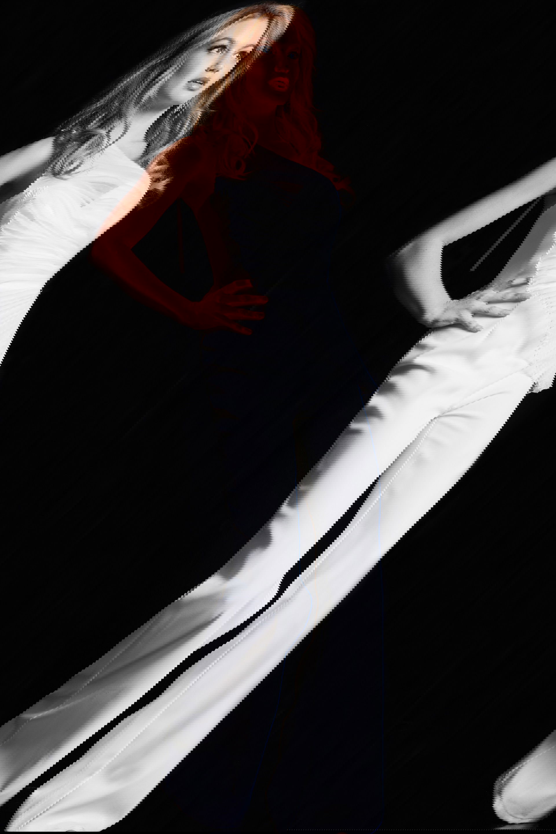 26171-WHITE-4.jpg model wearing 26171 elegant white jumpsuit with one-shoulder neckline and wide-leg trousers