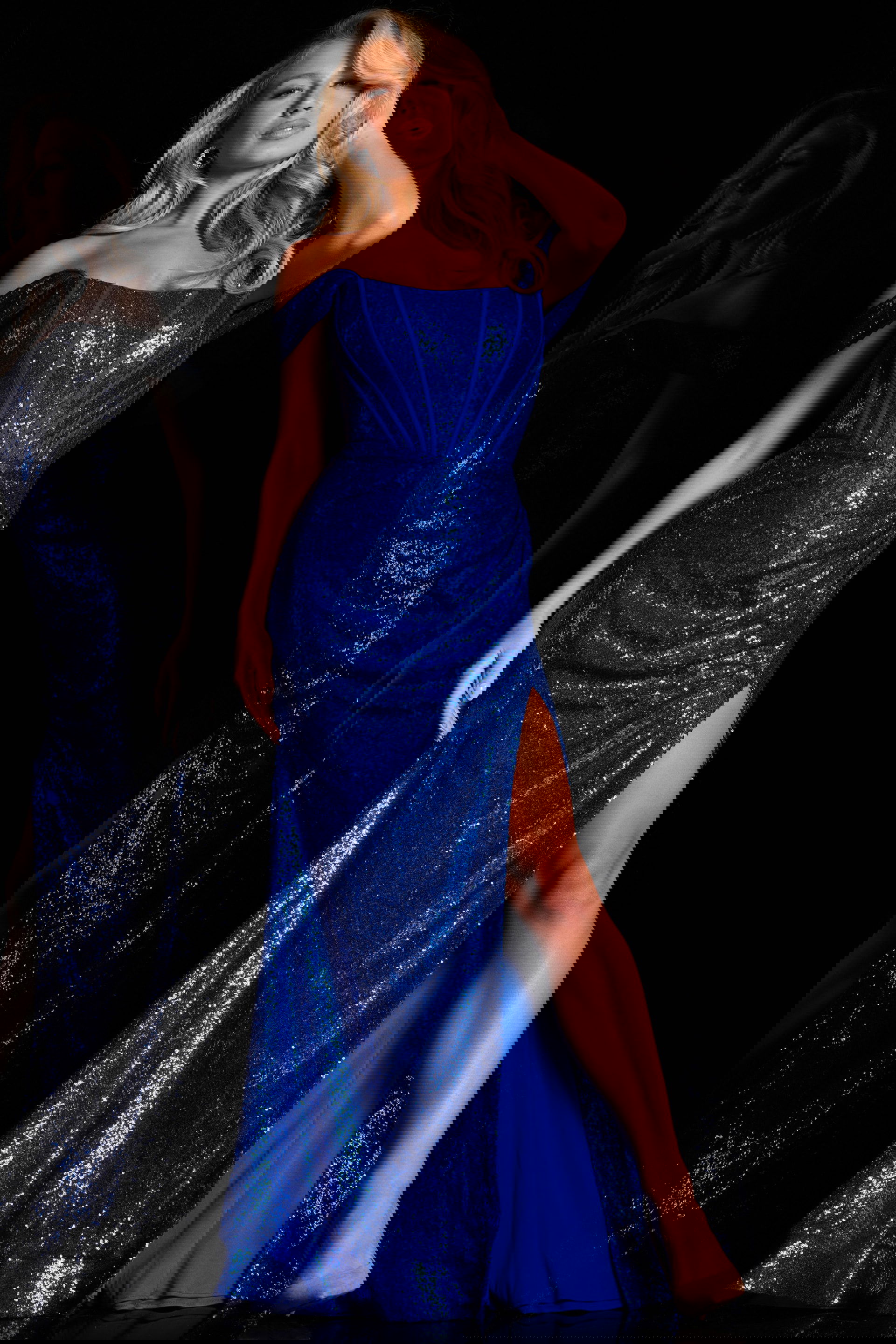 26172_2.jpg Model wearing Jovani 26172 royal blue sequin gown, front view with off-the-shoulder neckline and high slit.