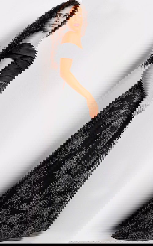 Model wearing Jovani 26186 elegant black gown, front view featuring off-the-shoulder neckline.