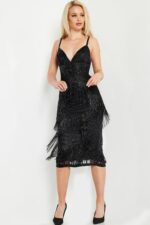 Model wearing Jovani 26192 black dress with intricate detailing, front view