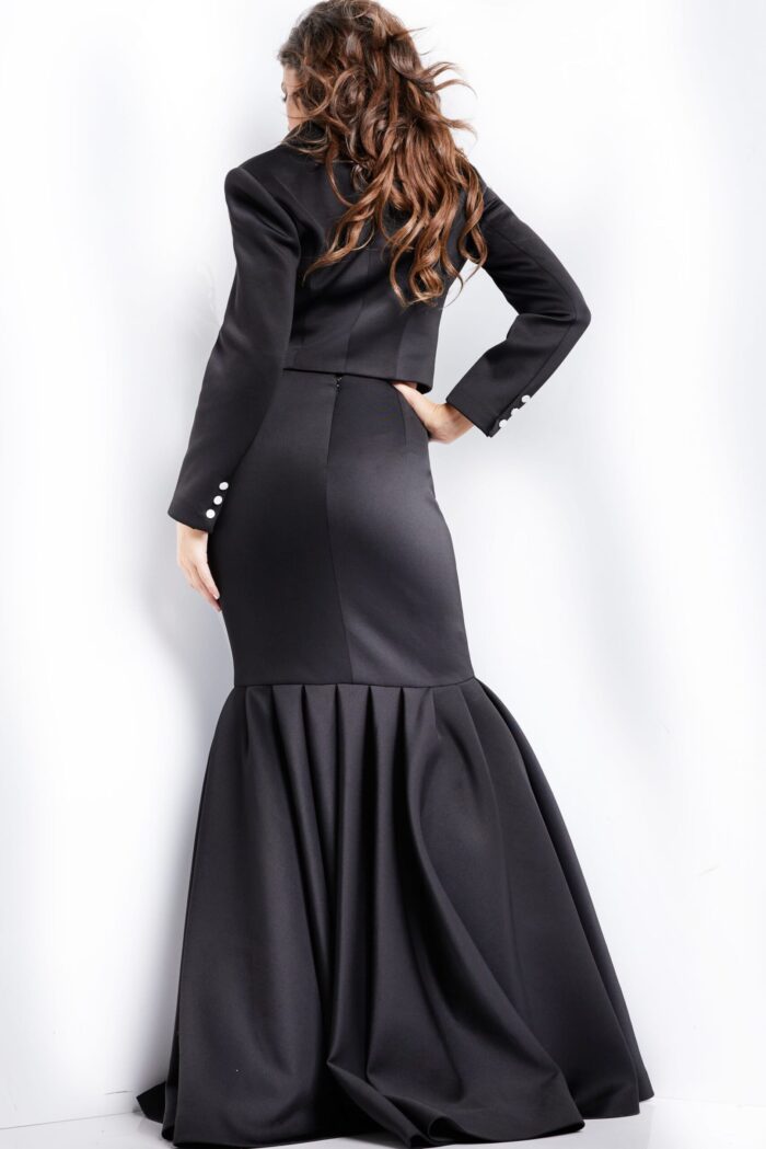 Model wearing Jovani 26199 sophisticated black dress with fishtail skirt, back view