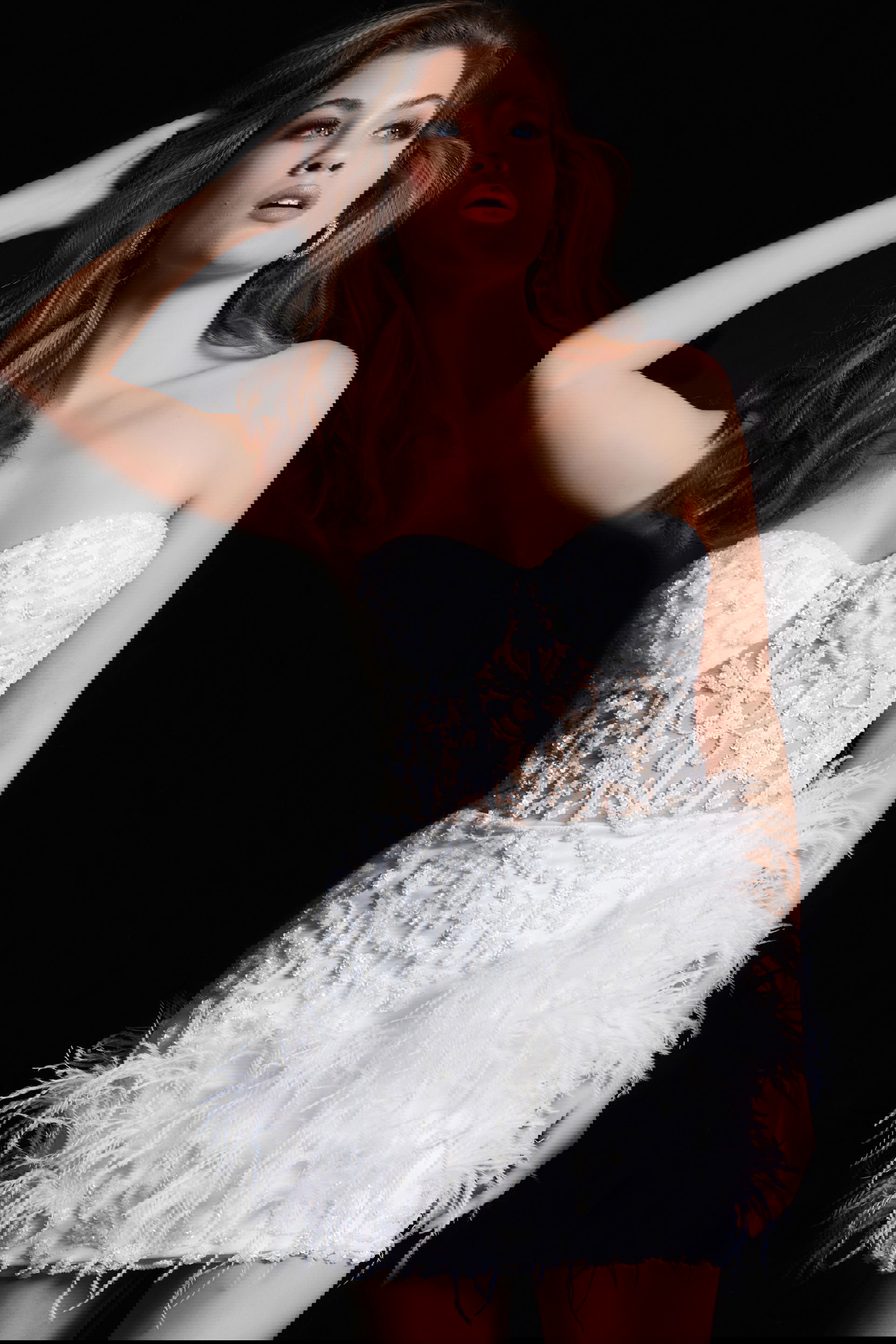 26226-WHITE-32.jpg Model wearing Jovani 26226 white dress with sweetheart neckline and feathers, front view.