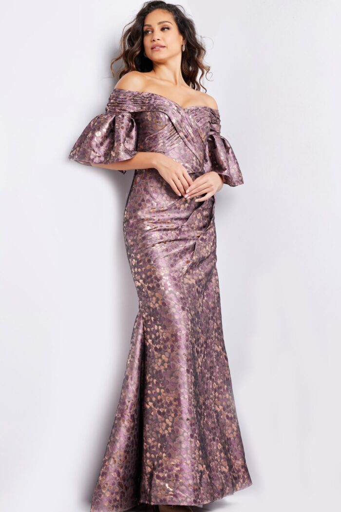 Model wearing Jovani 26258 gold dress with off-the-shoulder neckline, front view.