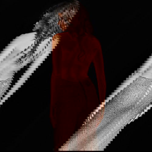 Model wearing Jovani 26268 taupe ombre dress, back view showing backless design.