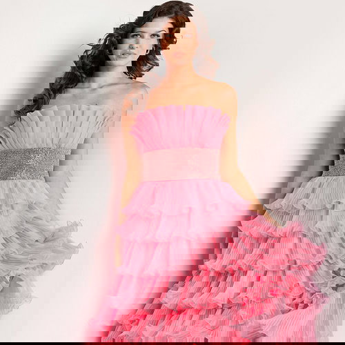 Model wearing Jovani 26314 pink gown with tiered ruffles, front view.