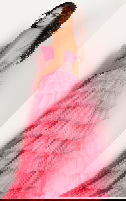 Model wearing Jovani 26314 pink gown with tiered ruffles, back view.