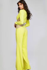 Side back angle of model wearing Jovani 26318 yellow jumpsuit with intricate waist design.