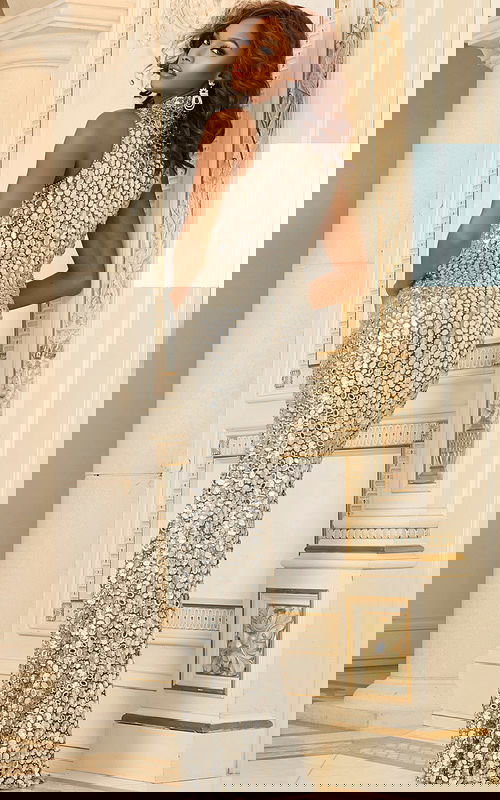 Model wearing Jovani 30054 back view in Nude color, showcasing sleeveless design.