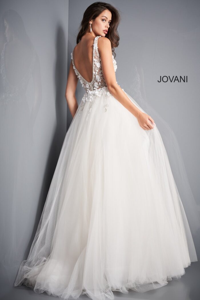 Model wearing Jovani 3110 ivory gown, highlighting the deep V-back design.
