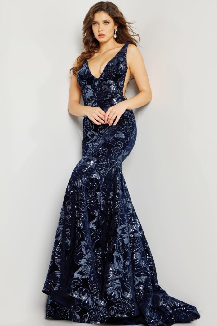 Model in Jovani 32581 navy dress, displaying the plunging neckline.