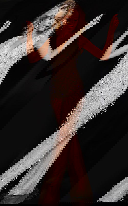 Model wearing Jovani 32592 nude gown posing with arms up, showcasing front details.