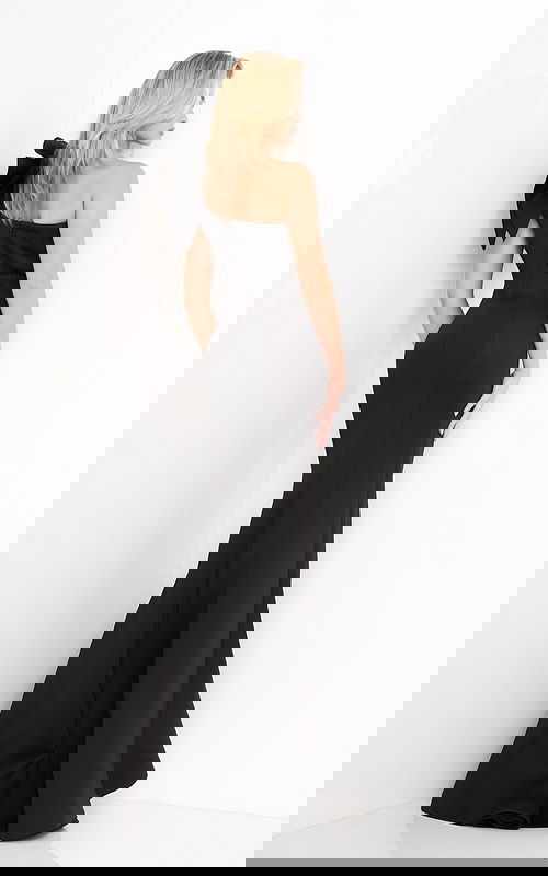 Jovani 32602 black gown's back view, highlighting the bow and fit