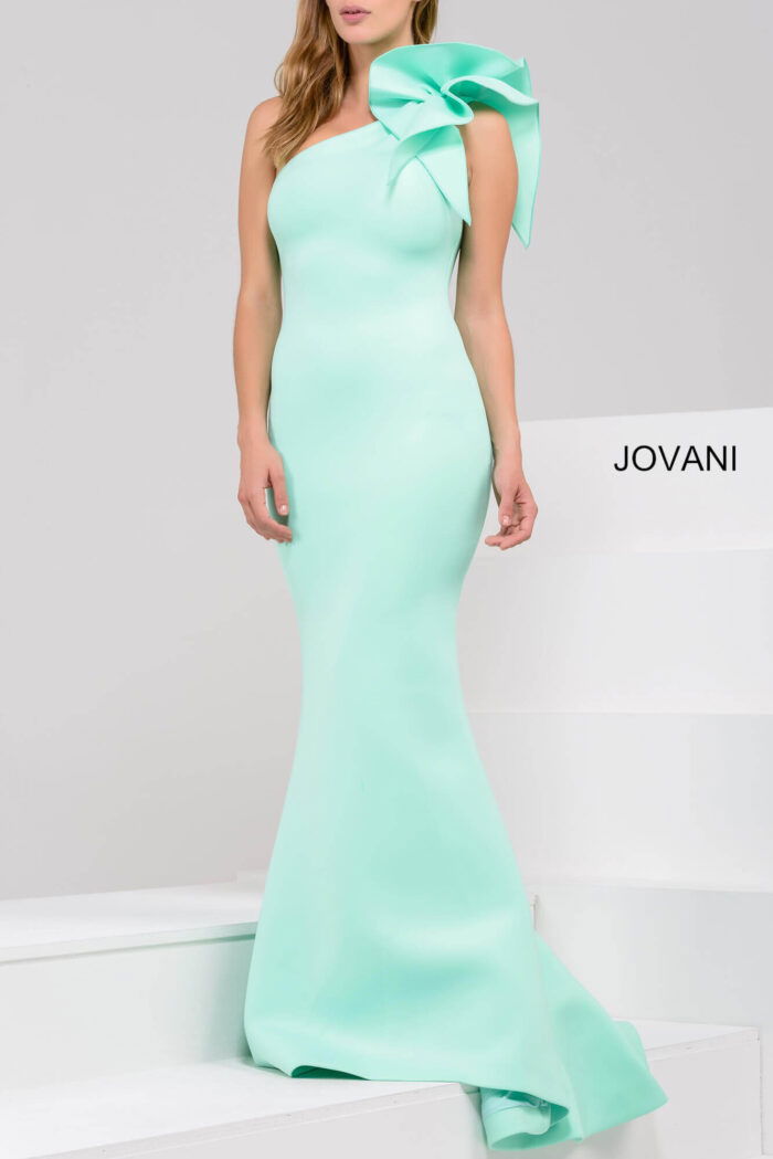 Model in Jovani 32602 mint green gown with mermaid silhouette