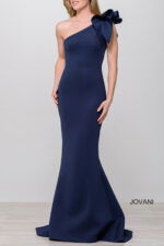 Model in Jovani 32602 navy gown, one-shoulder with bow