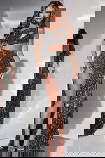 model wearing Jovani 34011 black gown with high slit and cutout