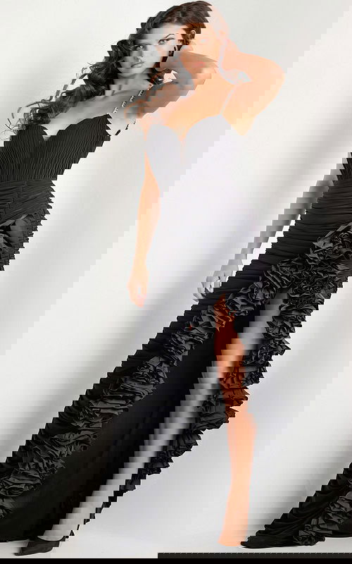 Model wearing Jovani 34392 black gown featuring a sweetheart neckline and high slit with ruffles.