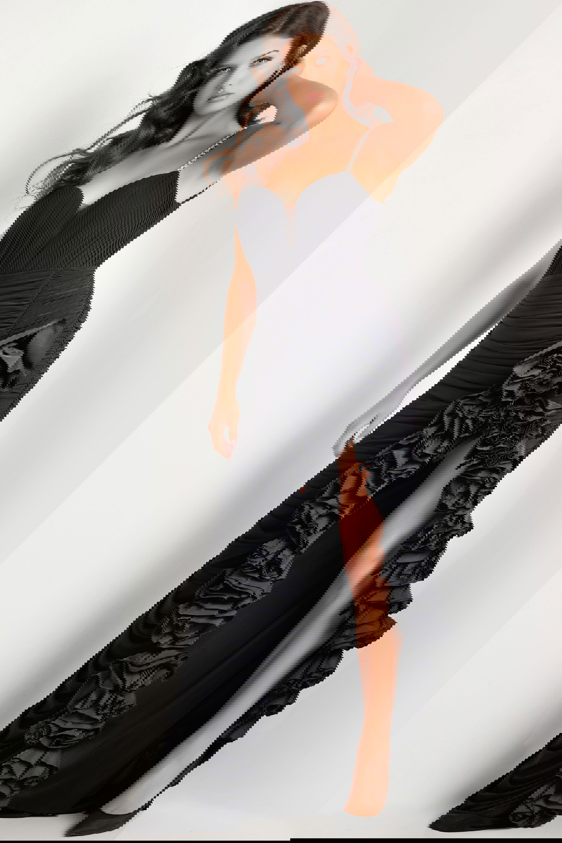 34392_black.jpg Model wearing Jovani 34392 black gown featuring a sweetheart neckline and high slit with ruffles.