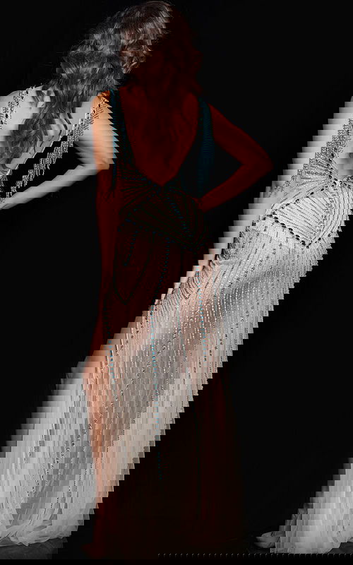 Model wearing Jovani 36422 nude dress, back view showing intricate design.