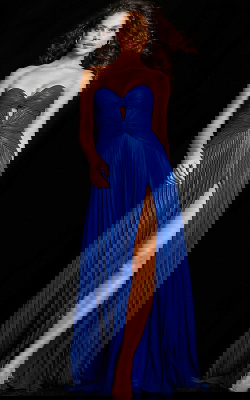Model wearing Jovani 36461 royal dress with sweetheart neckline and high slit