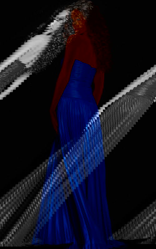 Model wearing Jovani 36461 royal dress, back view with detailed pleats