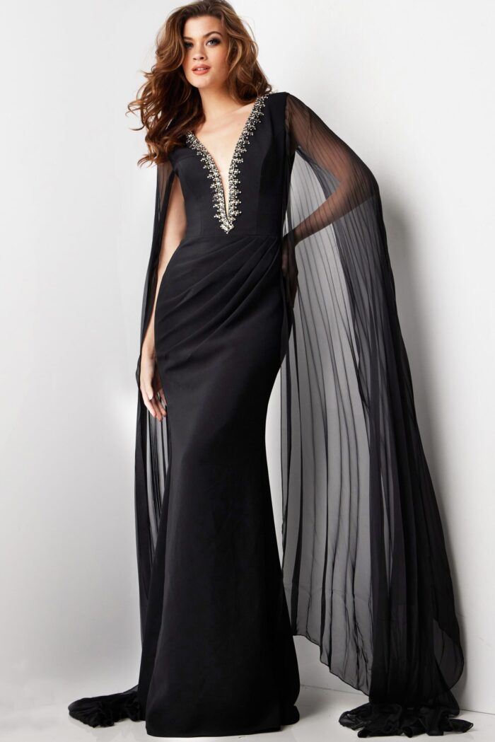 model in Jovani 36473 floor-length black gown with beadwork and cape sleeves