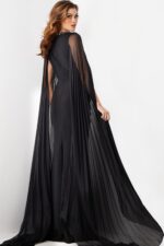 back view of model wearing Jovani 36473 elegant black gown with draped sleeves