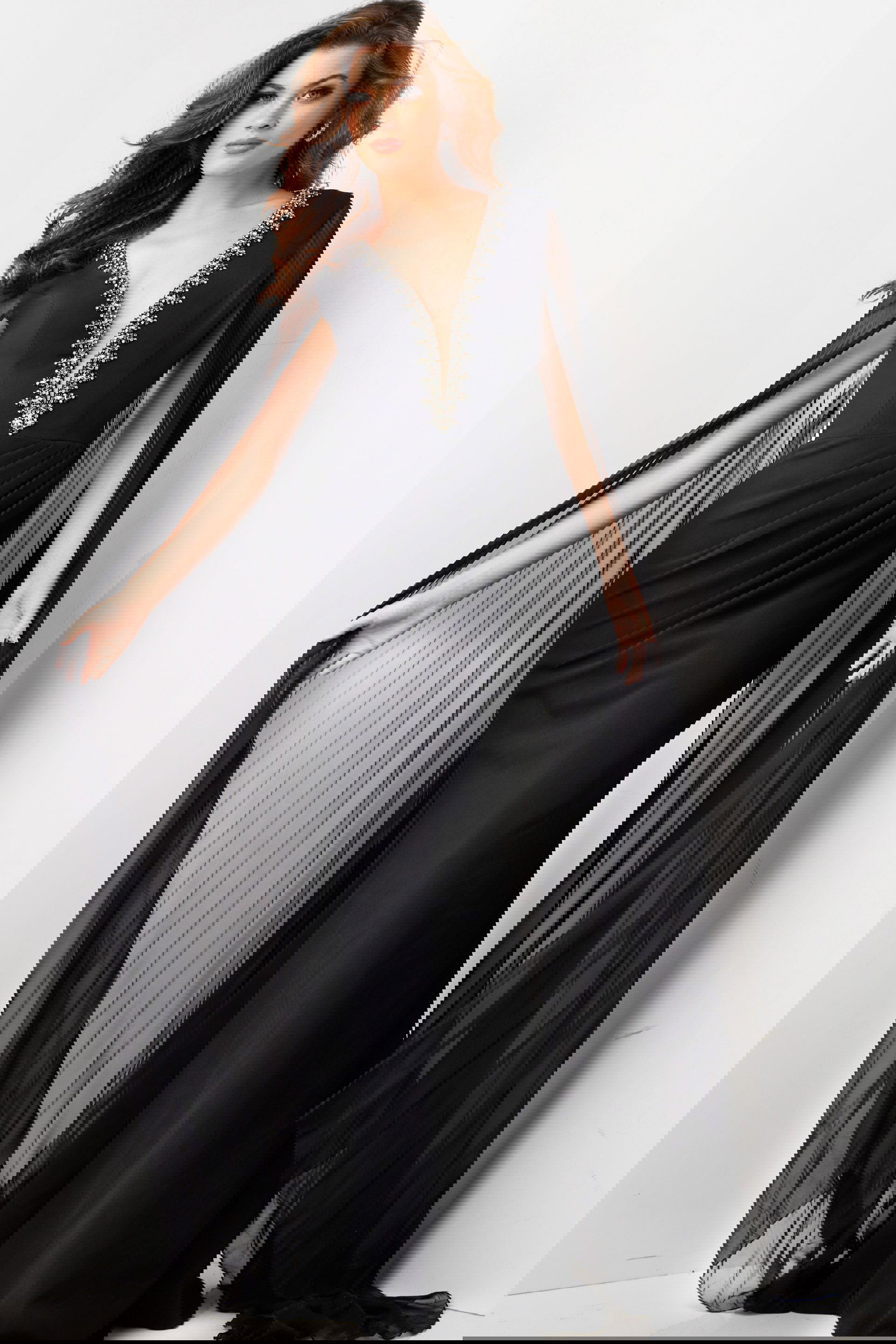 36473-BLACK-6.jpg model wearing Jovani 36473 elegant black gown with deep V-neckline and draped sleeves