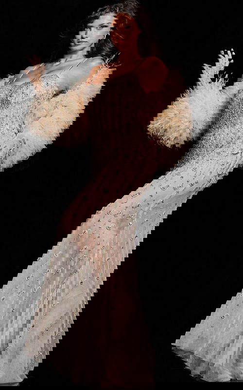 Model posing in Jovani 36510 nude gown featuring intricate beadwork, front angle view.