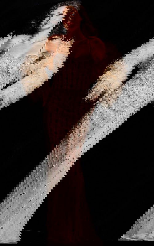 Model wearing Jovani 36510 nude gown with sweetheart neckline and feathered shrug, front view.