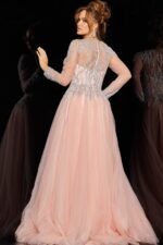 Back view of model in 36533 blush dress showcasing intricate beadwork.