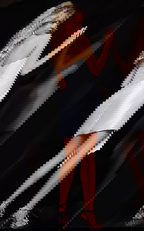 Model in Jovani 36596 ivory mini dress, back view