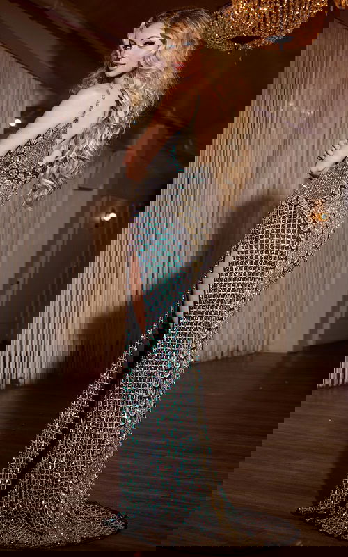 Back view of Jovani 36643 gown with embellishments and high slit in black.