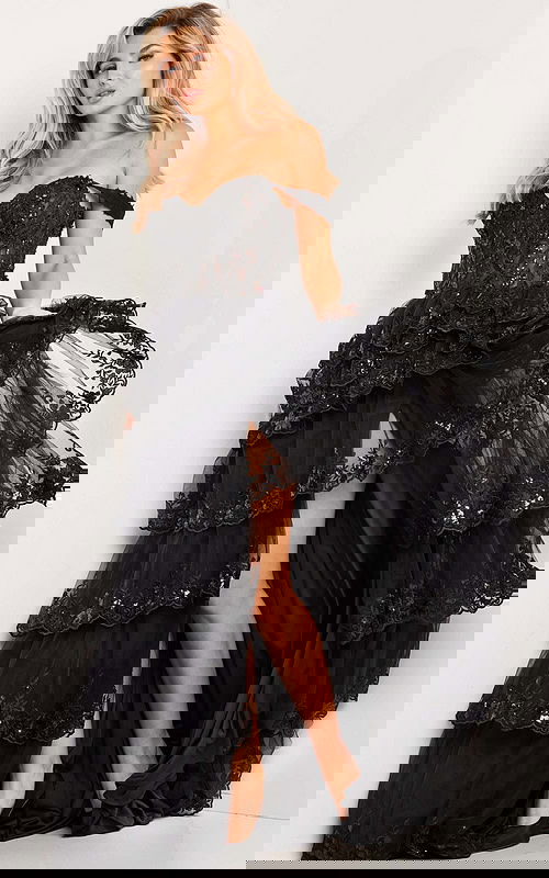 Model wearing Jovani 36687 elegant black gown with sweetheart neckline and high-low skirt.