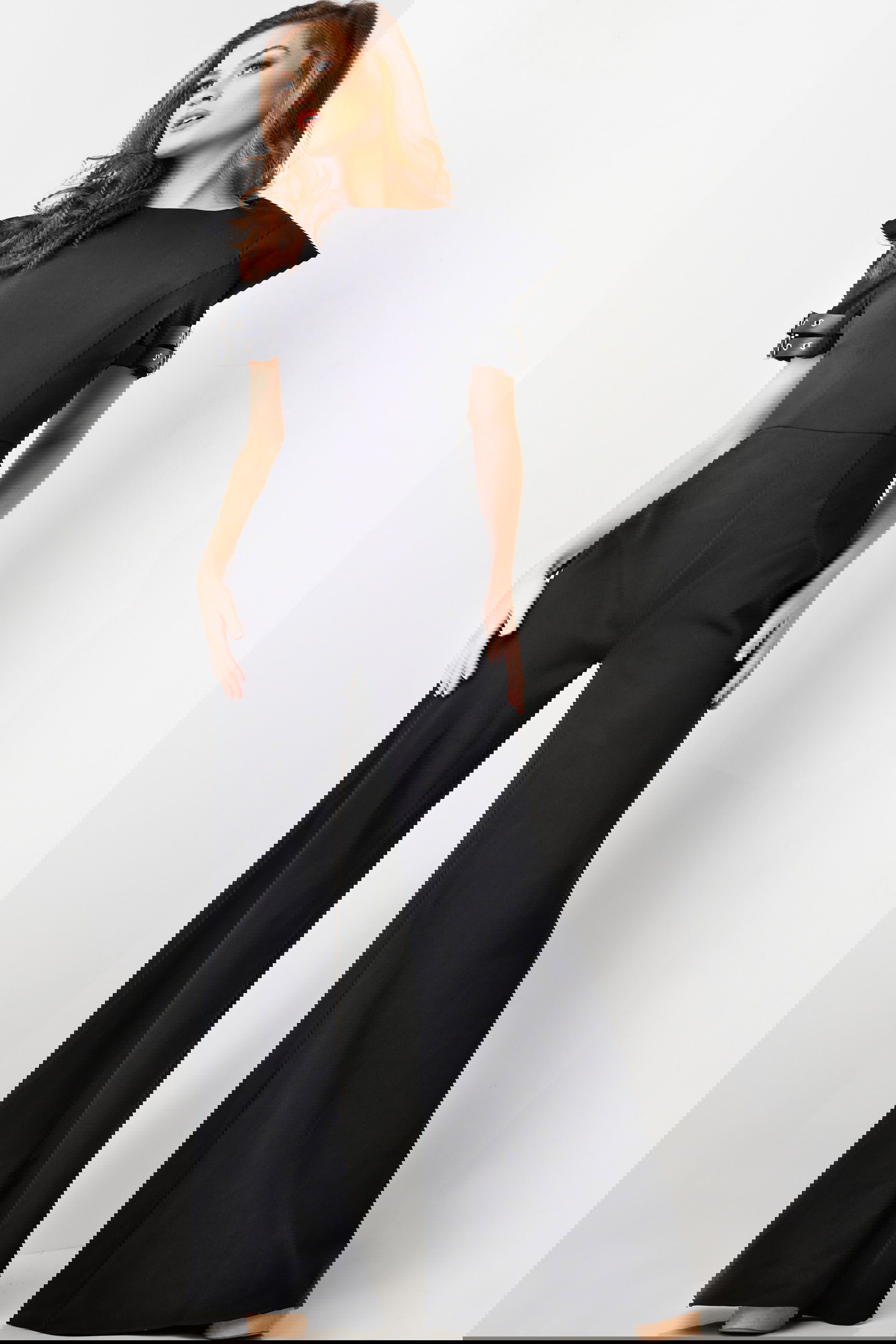 36692-BLACK-24.jpg model wearing Jovani 36692 elegant black jumpsuit with structured sleeves and buckle details