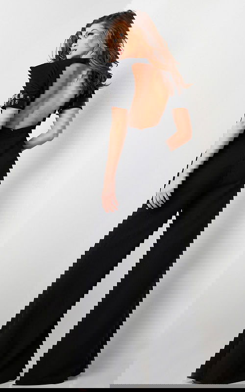 model wearing Jovani 36692 black jumpsuit with open back design