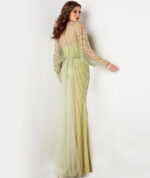 Back view of model wearing 36744 green dress highlighting beaded back design