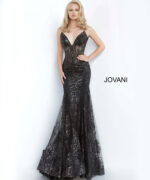 Model wearing Jovani 3675 black mermaid gown with lace detailing, front view