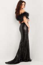 Model wearing Jovani 36808 black dress with off-shoulder feather detailing, back view.