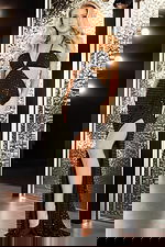 Model wearing Jovani 36810, black beaded gown with halter neck and high slit front view.