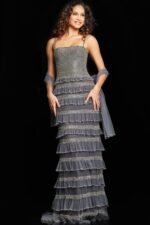 Model in Jovani 36816 silver gown with square neckline and tiered ruffle design.