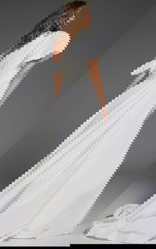 model wearing Jovani 36872 white one-shoulder gown with floral embellishments and high slit