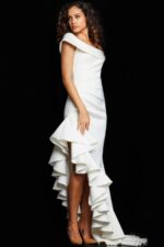 Model wearing Jovani 36910 white gown with off-the-shoulder neckline and ruffle detail, side view.