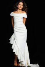Model wearing Jovani 36910 white gown with off-the-shoulder neckline and ruffle detail, front view.